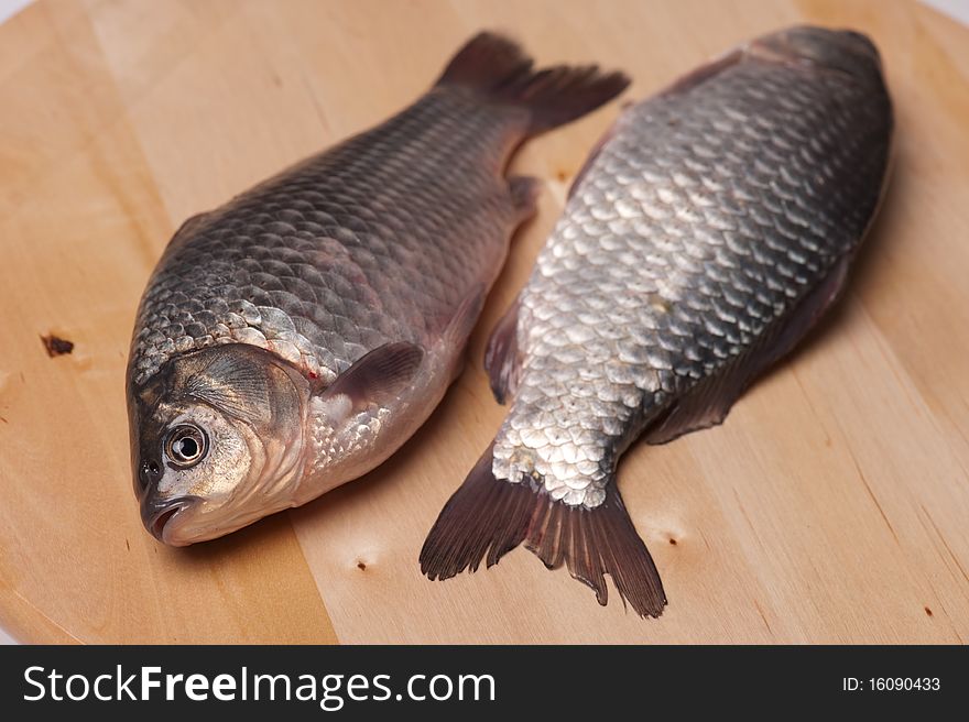 Two alive fish on the cooking desk. Two alive fish on the cooking desk