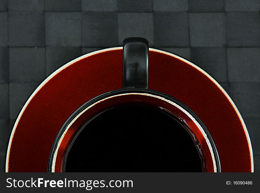 Half black coffee in black and red cup