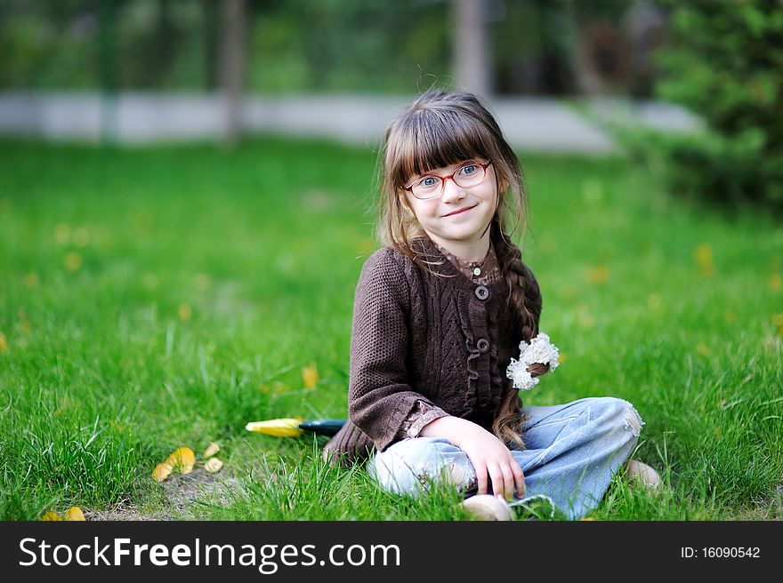 Adorable little girl with beauty blue eyes in glas