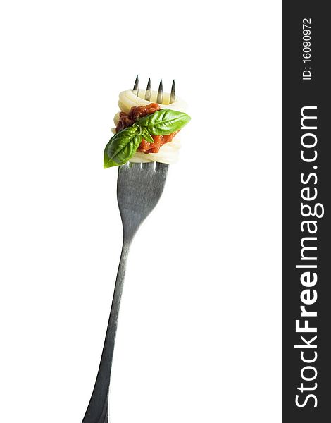 Pasta with basil on fork (isolated on white)