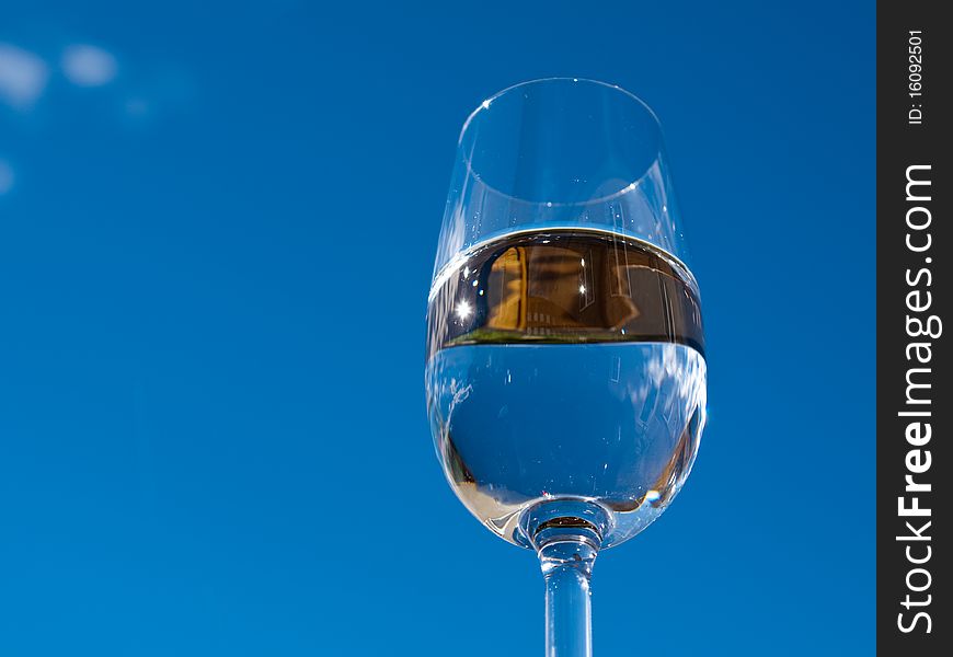Refreshing glass of pure water against a blue sky. Refreshing glass of pure water against a blue sky