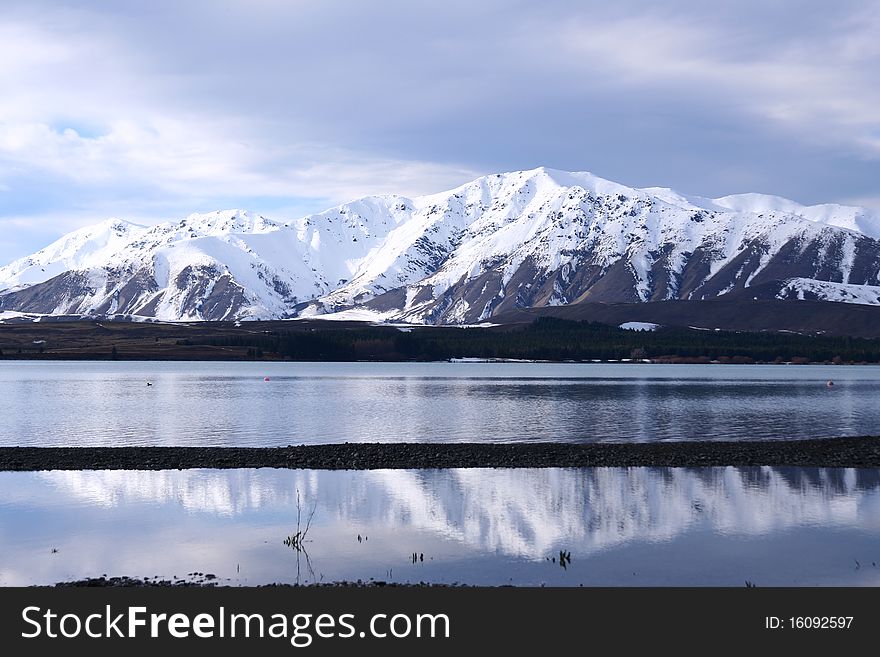 The spectacular view of Lake Tekapo, New Zealand, in winter with the snow mountain backdrop. The spectacular view of Lake Tekapo, New Zealand, in winter with the snow mountain backdrop.