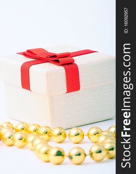 A white gift box with red ribbon