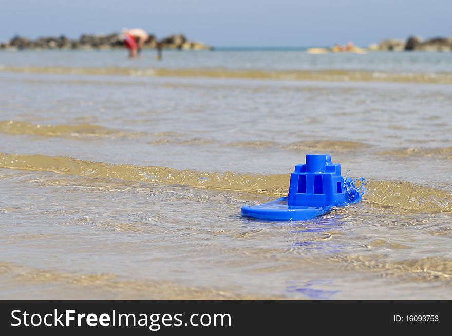 Small boat made of blue plastic in the sea. Small boat made of blue plastic in the sea