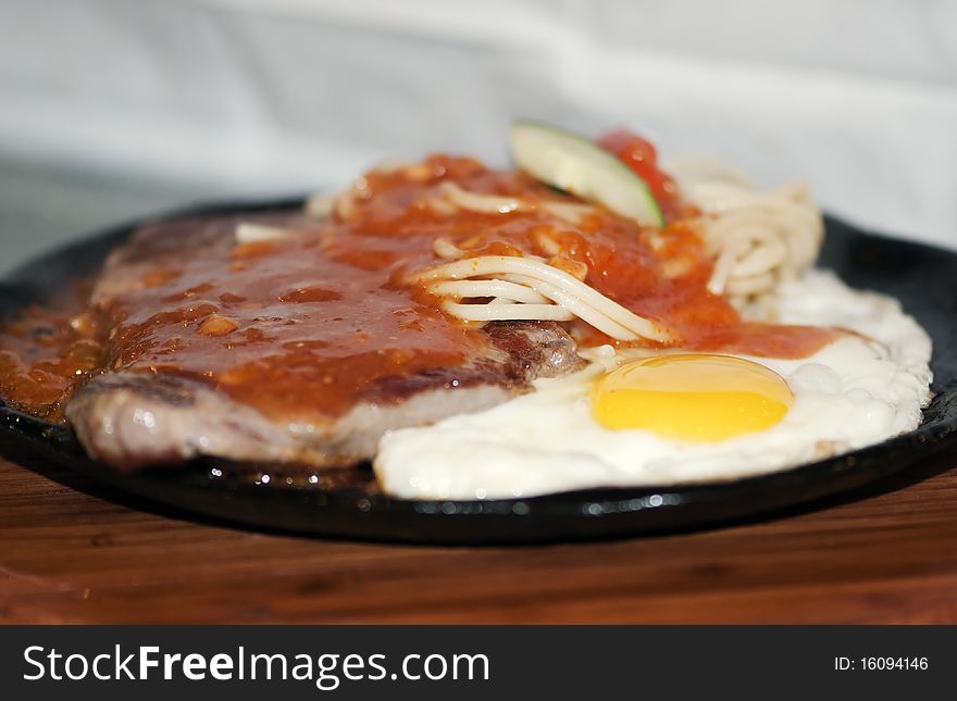 Palatable iron plate of delicious food beefsteak. Palatable iron plate of delicious food beefsteak