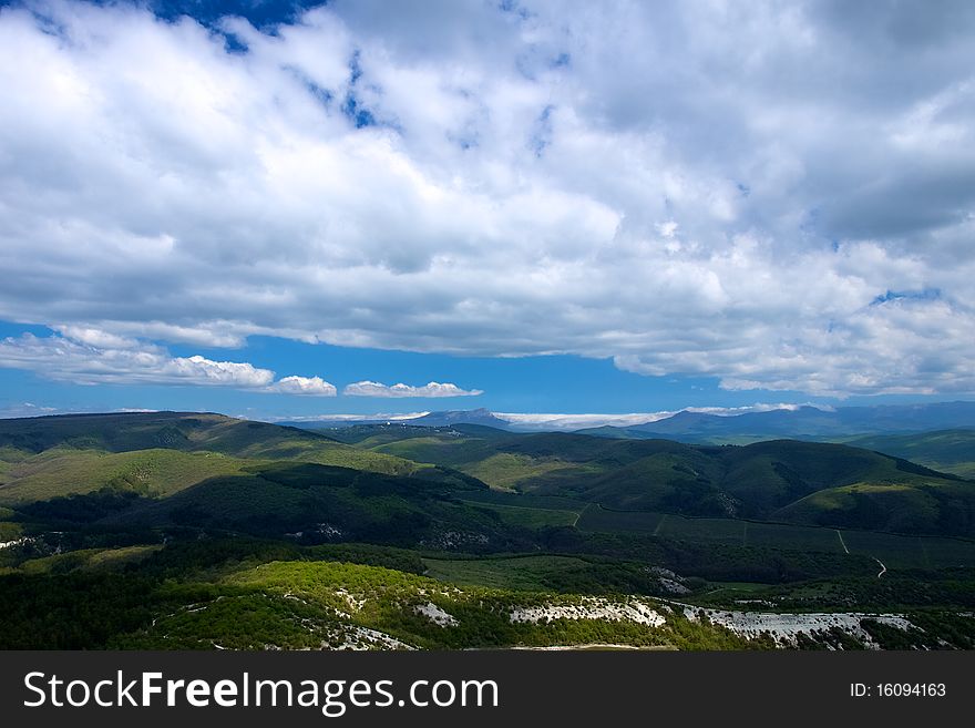 Beautiful mountain landscape with sailing on the blue sky with white clouds. Beautiful mountain landscape with sailing on the blue sky with white clouds
