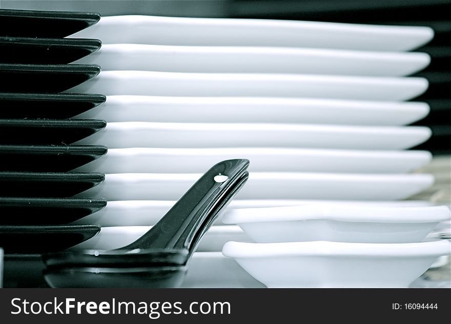 Stack of white and black plates. Stack of white and black plates