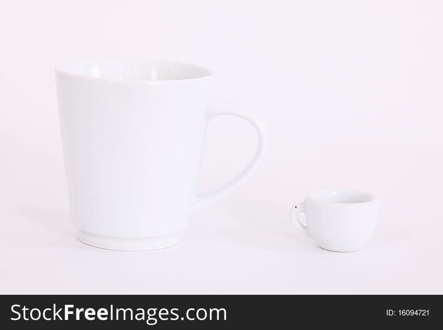 Big and small white cups over blank background