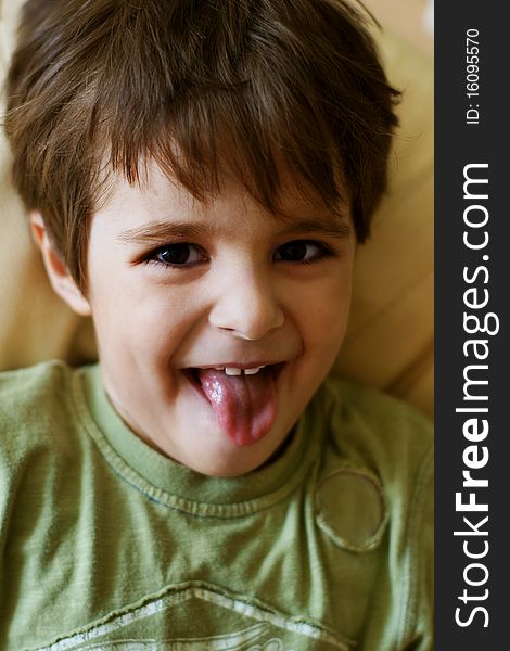 Portrait of playful little boy showing his tongue. Portrait of playful little boy showing his tongue