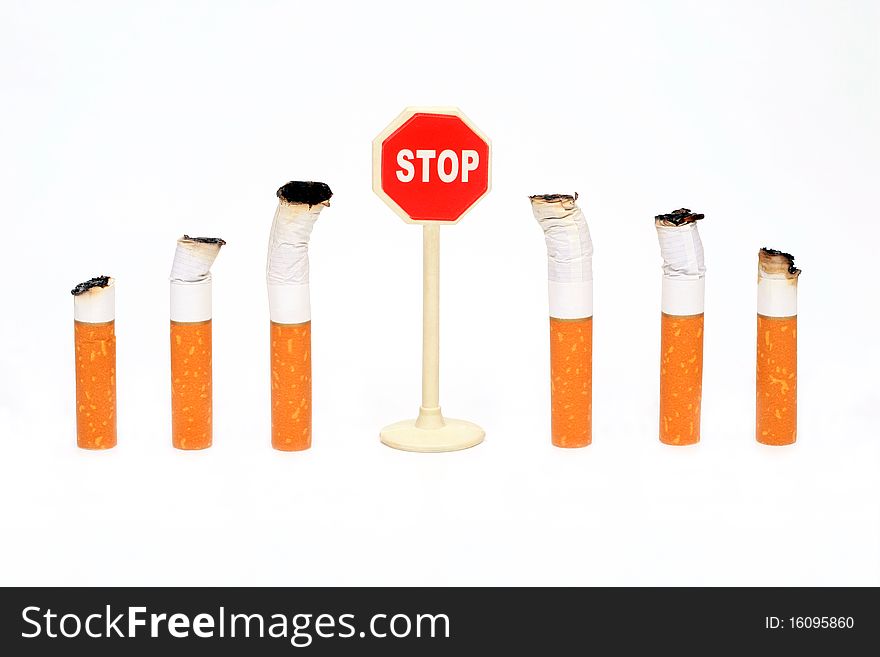 Cigaret Stubs Stand From Two Parties Before A Sign