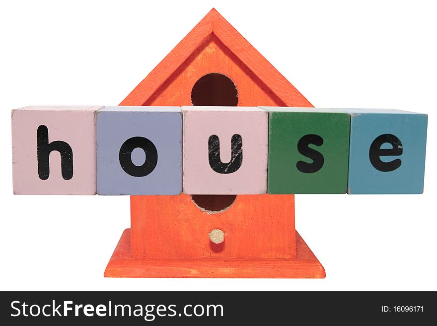 Toy letters that spell house against a birdhouse with clipping path. Toy letters that spell house against a birdhouse with clipping path
