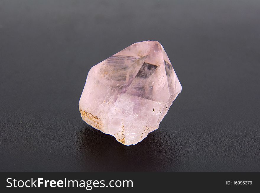 Large amethyst crystal on a gray background