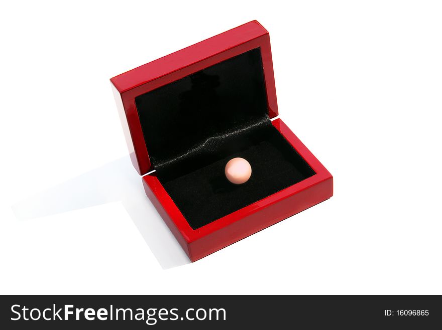 Pink pearl in a red gift box