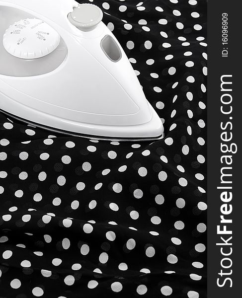 Ironing delicate black and white silky fabric. Ironing delicate black and white silky fabric.