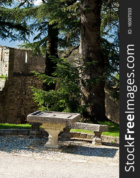 Stone table in the courtyard side Thun Castle in summer under the sun