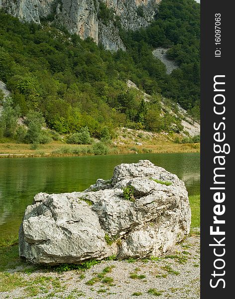 A beautiful park at the foot of a mountain in summer, with a natural lake. A beautiful park at the foot of a mountain in summer, with a natural lake