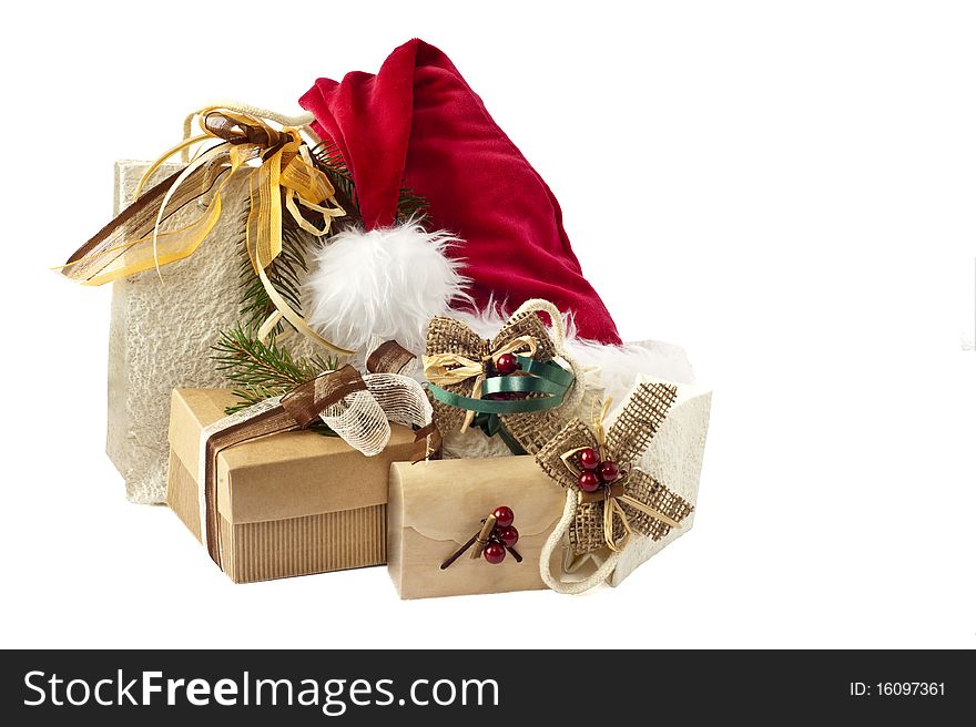 Hat of Santa Claus and gifts on white background