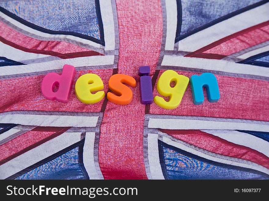 An image of the word 'design' in colorful lower case letters on the Union Jack flag as backdrop. This is a concept image of 'designed in Britain' or 'British by design'. An image of the word 'design' in colorful lower case letters on the Union Jack flag as backdrop. This is a concept image of 'designed in Britain' or 'British by design'.