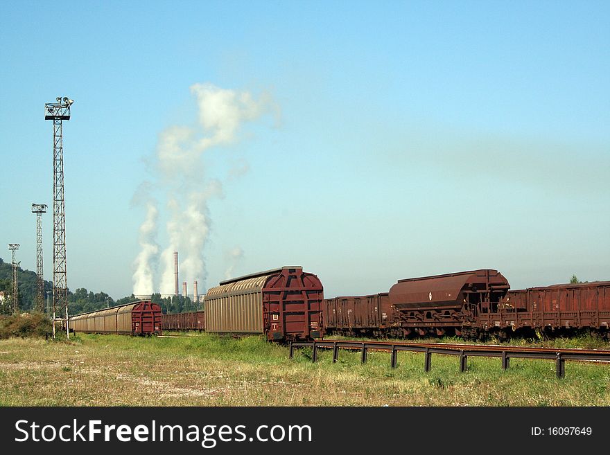 Trains with industry chimneys in background. Trains with industry chimneys in background
