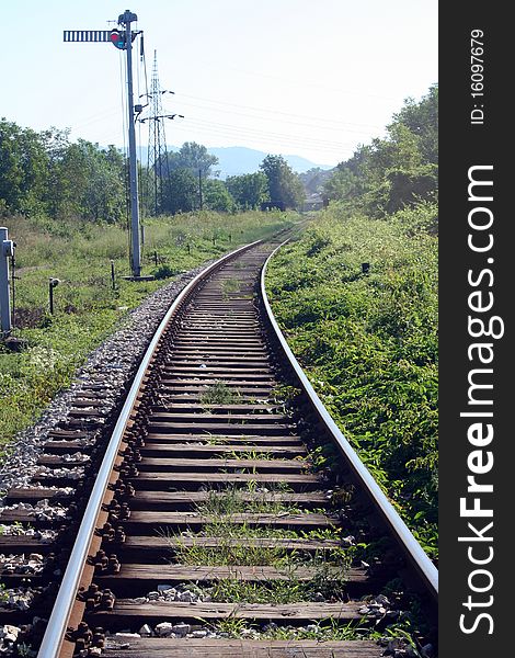 Nature scene with railway and traffic light