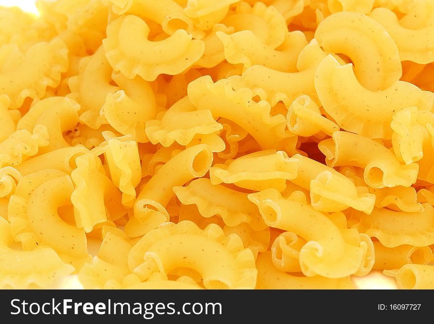 Yellow italian pasta over the white background. Yellow italian pasta over the white background