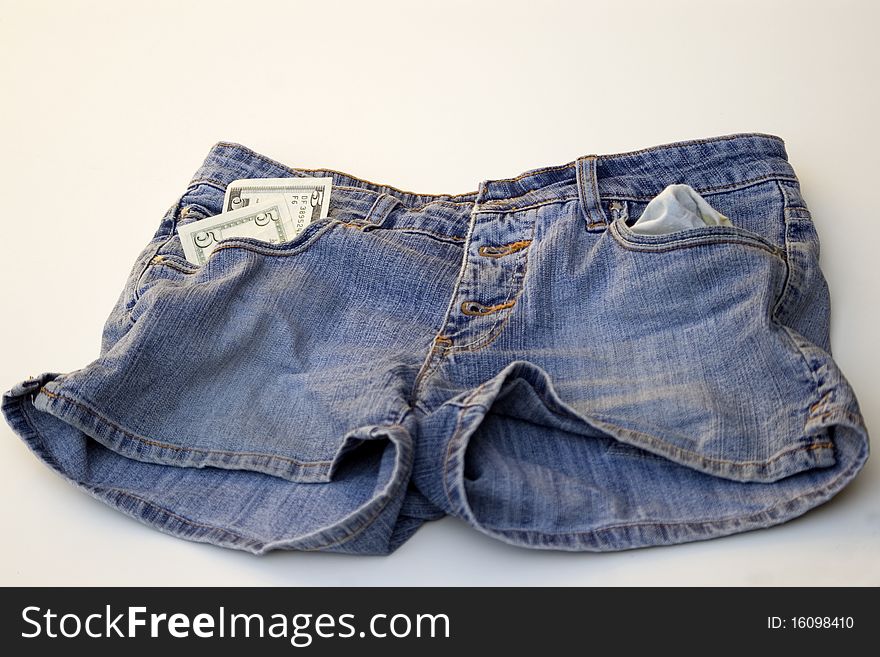 USA five dollars in pocket of jeans shorts.