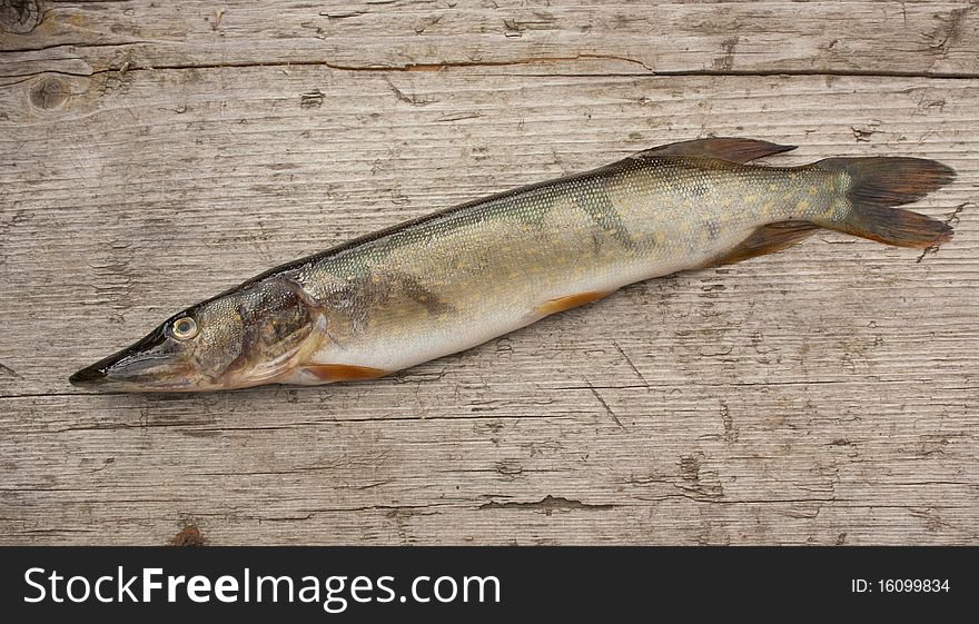 Freshwater fish lying on a wooden background. Freshwater fish lying on a wooden background