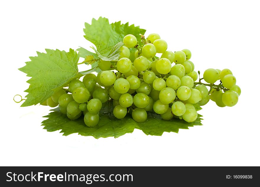 Bunch of fresh grapes and leaves isolated on white