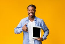African American Man Showing Tablet Screen Gesturing Thumbs-Up, Studio Shot Royalty Free Stock Photography