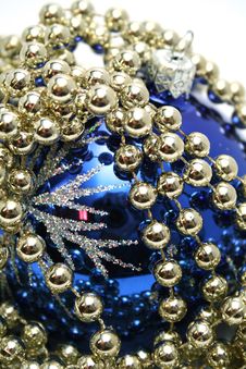 Blue Glass Sphere And Celebratory Beads On A White Stock Photography