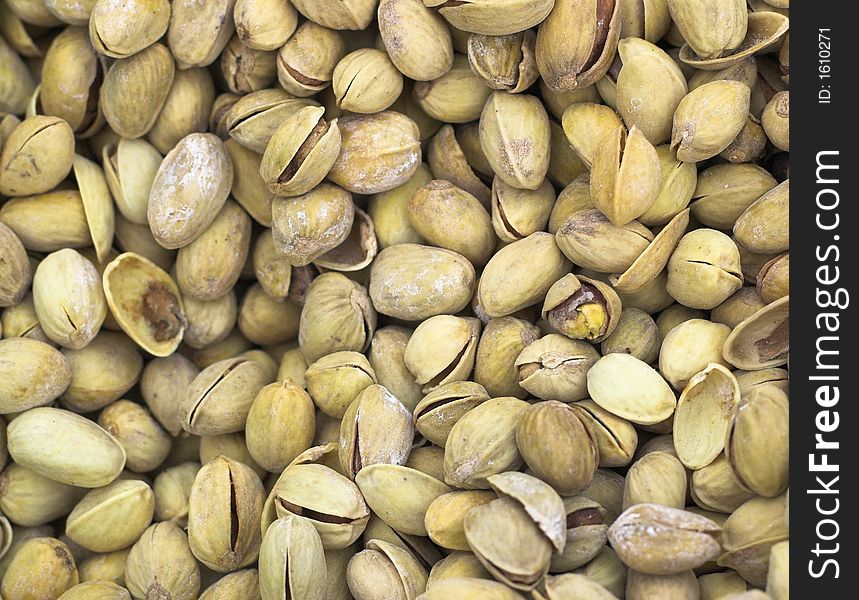 Whole pistachios stored in a mass background texture. Whole pistachios stored in a mass background texture
