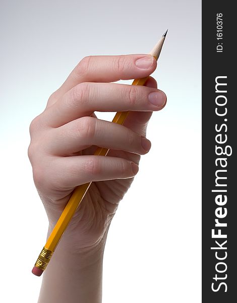 Hand with a pencil, on a blank white paper.