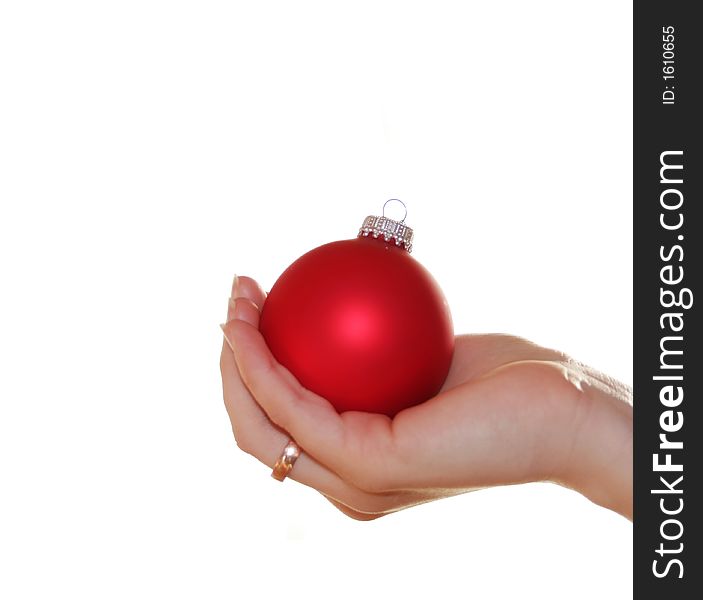 A white christmas background with a red christmas ball in the hand of a woman - very shiny. A white christmas background with a red christmas ball in the hand of a woman - very shiny