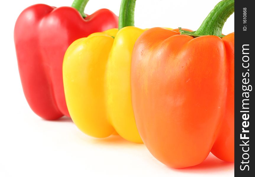 Close up of red, yellow and orange peppers isolated on white. Close up of red, yellow and orange peppers isolated on white