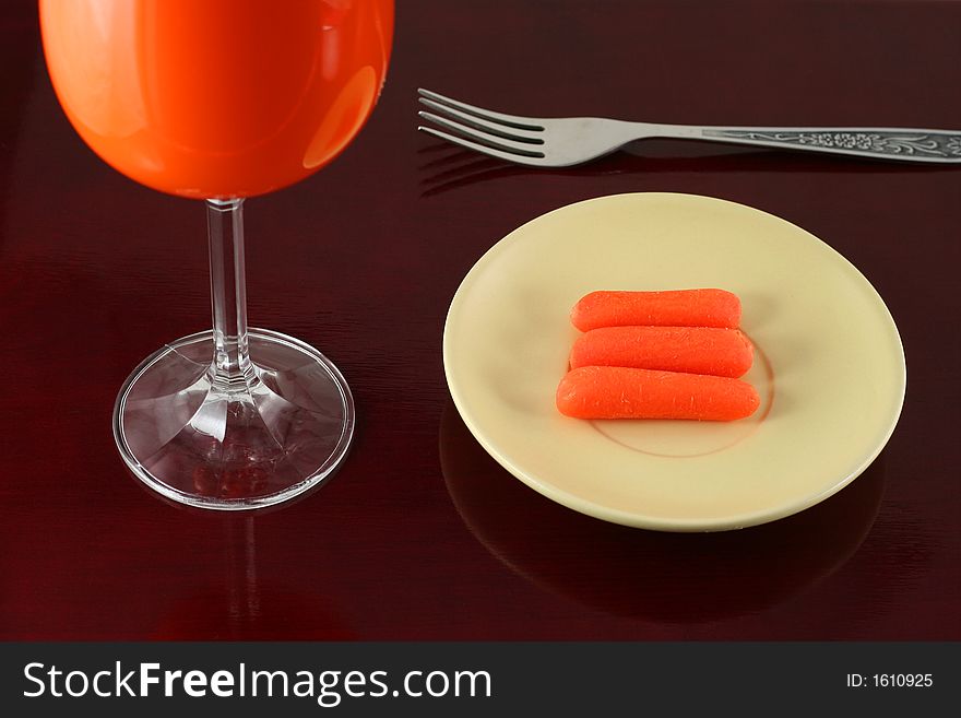 Carrots and it's juice on wooden background