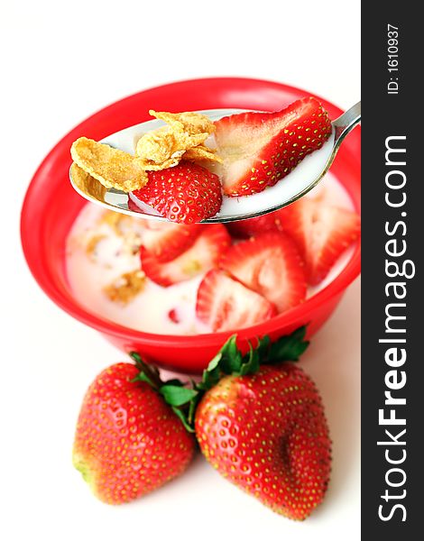 Strawberries cereal and milk, narrow focus - isolated on white. Strawberries cereal and milk, narrow focus - isolated on white