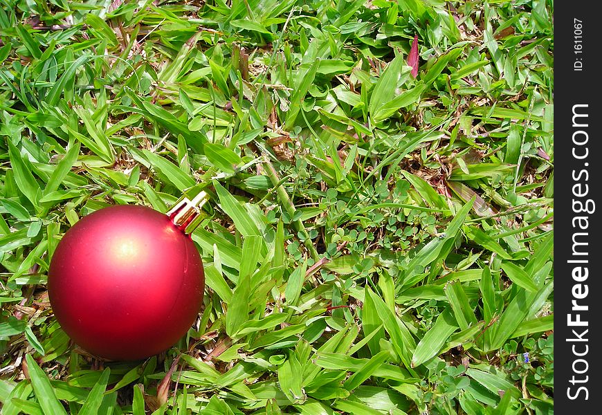 Single christmas ball against grass background - christmas decoration. Single christmas ball against grass background - christmas decoration