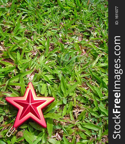 Single christmas star against grass background - christmas decoration with copyspace. Single christmas star against grass background - christmas decoration with copyspace