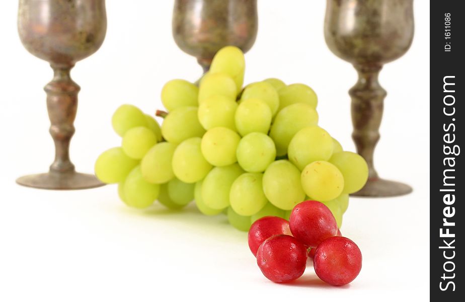 Close up of grapes with vintage wine glasses isolated on white - narrow focus