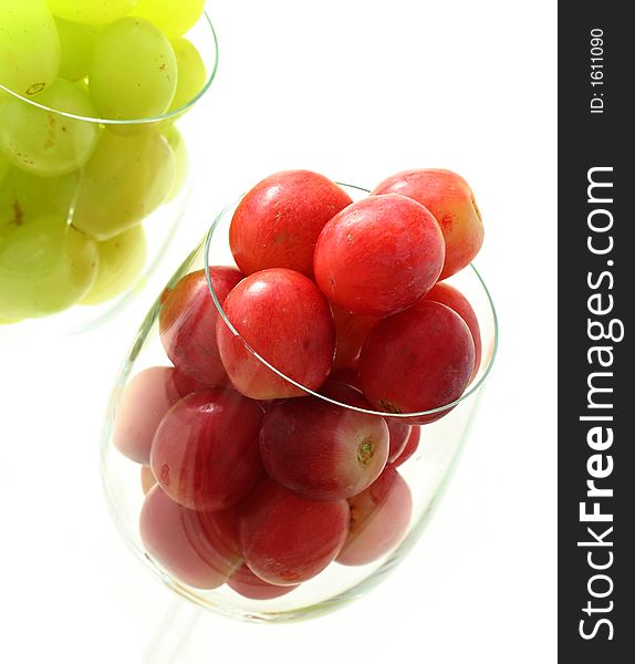 High key image of grapes in the wine glasses isolated on white. High key image of grapes in the wine glasses isolated on white