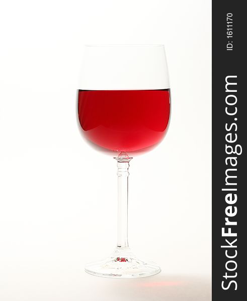 High key image of red wine in a glass isolated on white. High key image of red wine in a glass isolated on white