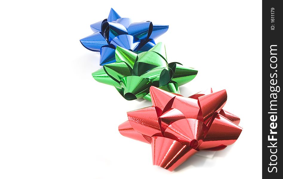 Red green and blue christmas bows over white. Red green and blue christmas bows over white