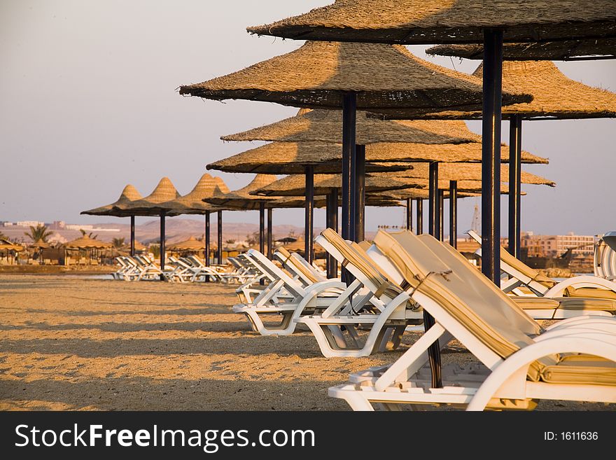 Sunbeds and parasols on the beach in the morning