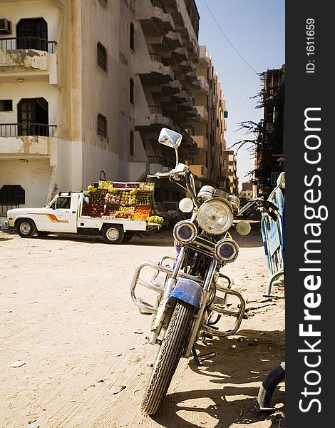 Classic landscape in Safaga (Egypt). motorbike and lorry with fruits and vegetables.