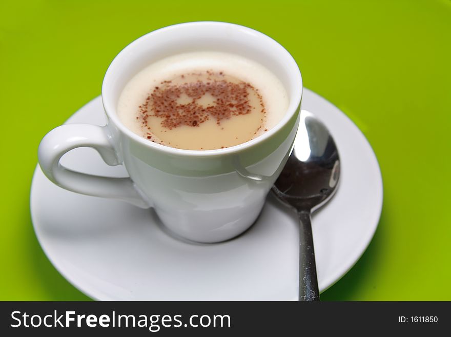 Cup of Cappucino coffee in white cup and saucer