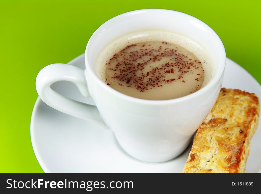 Cup of Cappucino coffee in White Cup and with Biscuit