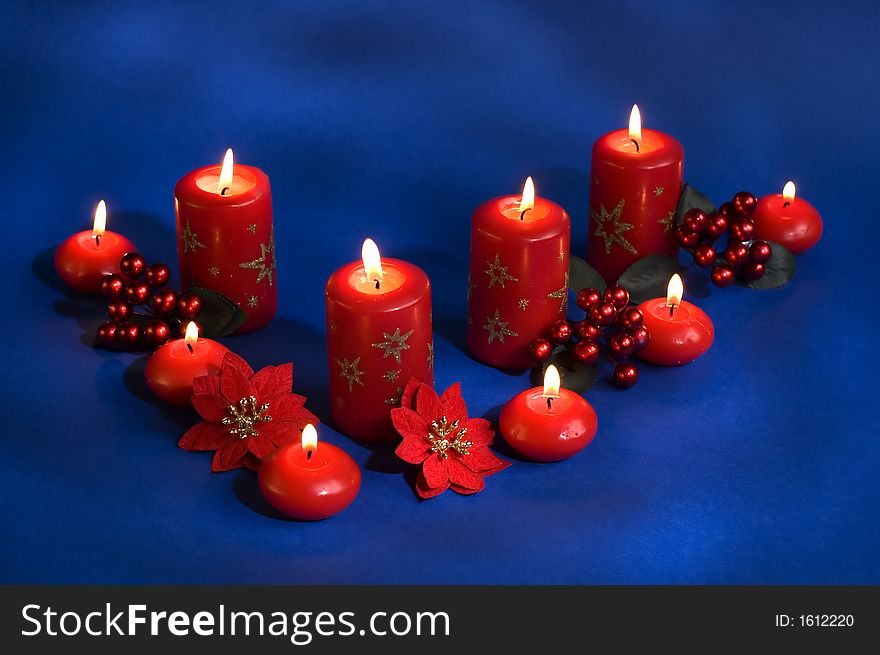 Red candles assorted on a blue background