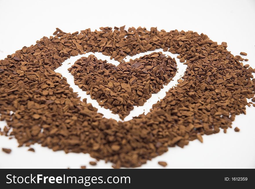 A heart made of coffee against white background. A heart made of coffee against white background