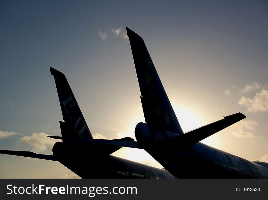 Silhouette of two jet wings looking into bright sunlight with blue sky. Silhouette of two jet wings looking into bright sunlight with blue sky