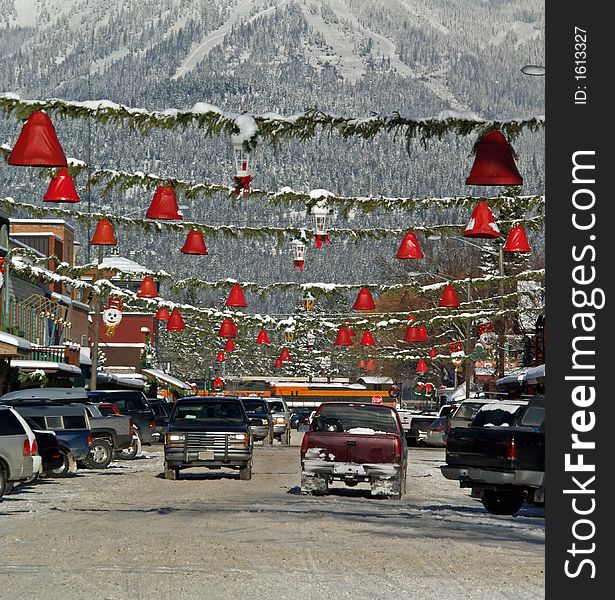 This image of the street, decorations, and snowy mountain was taken in western MT. This image of the street, decorations, and snowy mountain was taken in western MT.